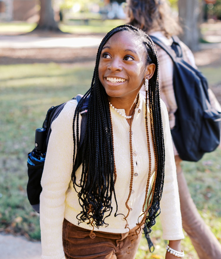 A residential undergraduate student walking on campus